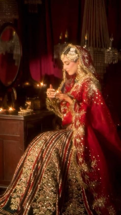 Portrait of the bride in full wedding jewellery and red attire