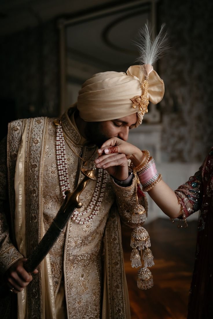 Portrait of the groom in a cream sherwani and turban
